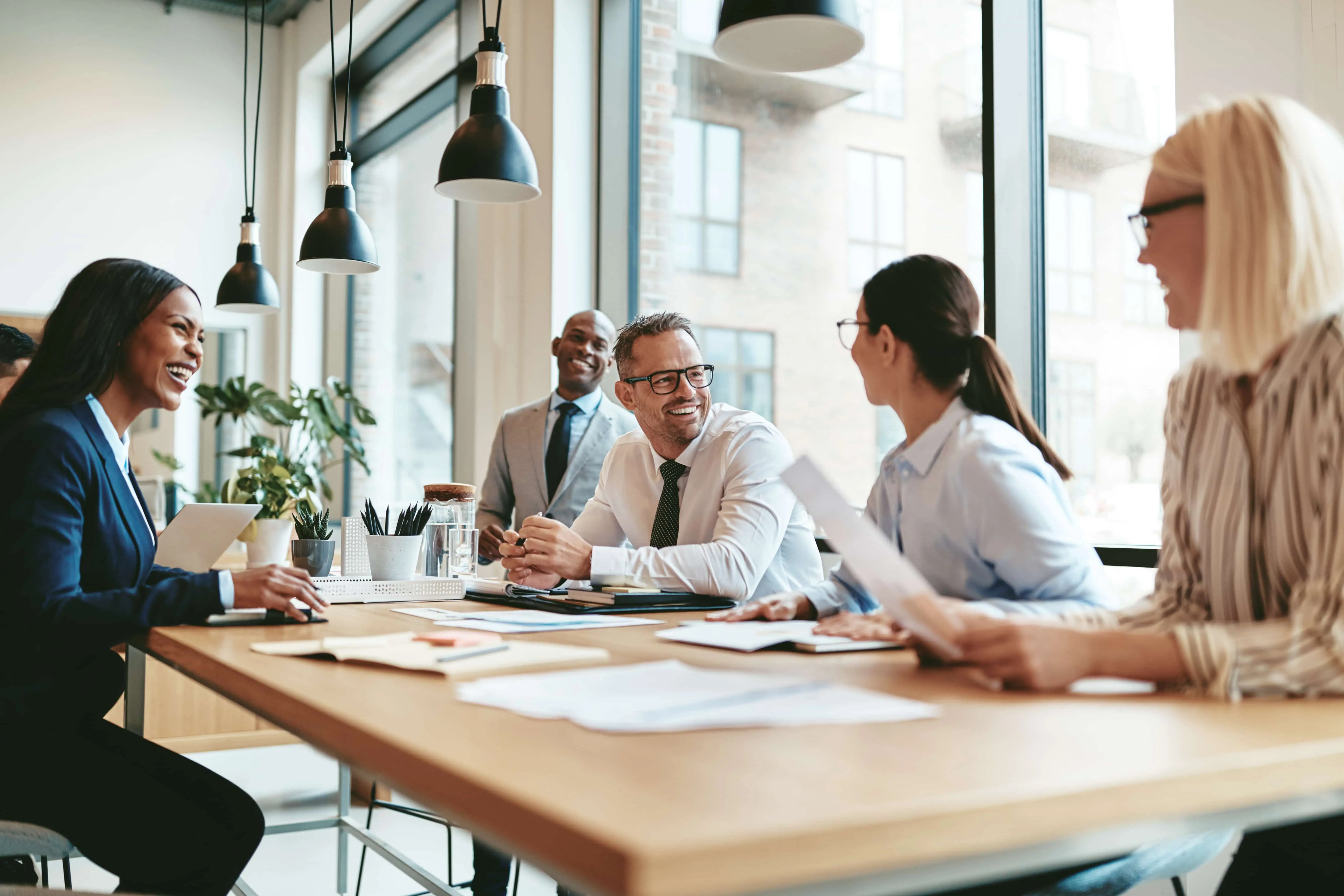 Stock photo of coworkers speaking at a conference table