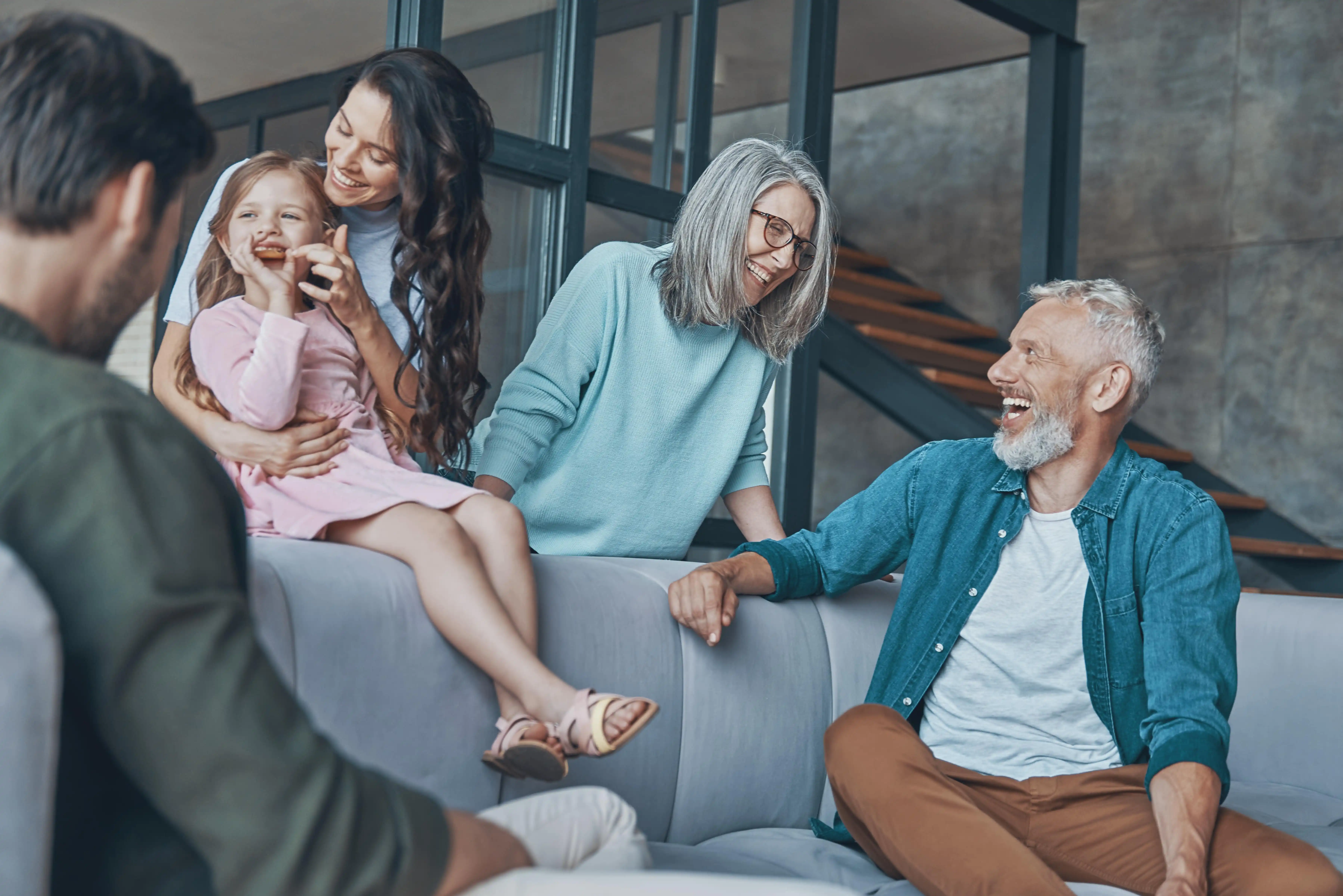 Photo of happy family sitting on couch